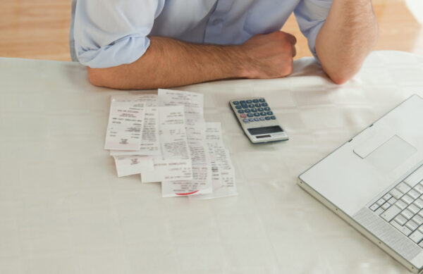 Young businessman checking his bills